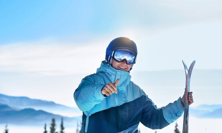portrait-skier-ski-resort-background-mountains-blue-sky